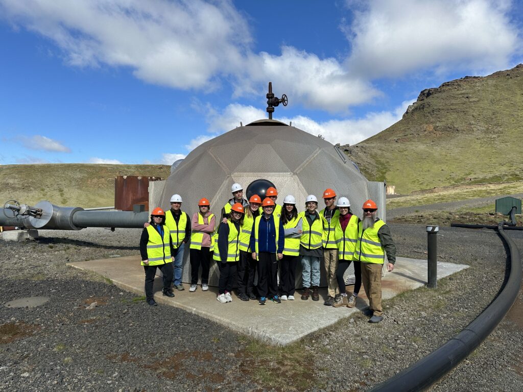 Students in safety gear standing in front of an injection well