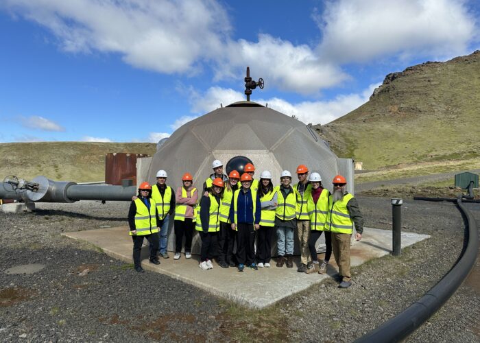 Students in safety gear standing in front of an injection well