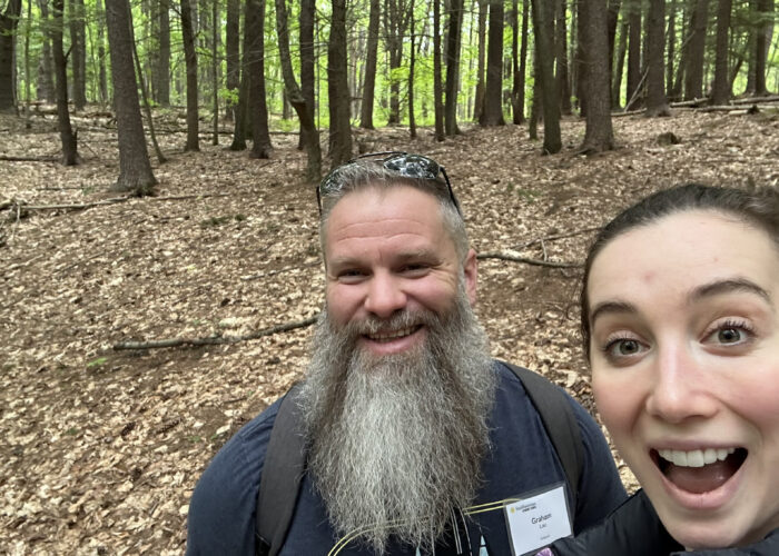 Headshot picture of Graham Lau and Grace Cordsen standing in a forest in Vermont